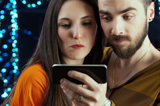 man and a woman, gleefully taking a selfie during their vacation night amidst city or party lights. Enjoying vacations feels like truly living, making the return to mere survival something to be kept