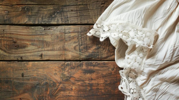 A piece of cloth lies on top of a wooden wall, creating a simple yet rustic composition. The texture of the wood contrasts with the softness of the fabric, adding interest to the scene.