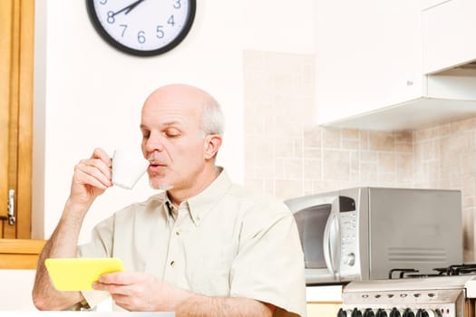 During breaks, senior engages with smartphone, tablet. Reflecting older generation's deep appreciation for tech, he earnestly navigates, yet grapples with separating dependable from spurious content