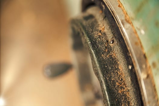 Small detail in focus of an adjustment, knob or in an element of woodworking tools, while the rest remains out of focus. Atmosphere and light in a craftsman carpenter's workshop. Wood and metal.