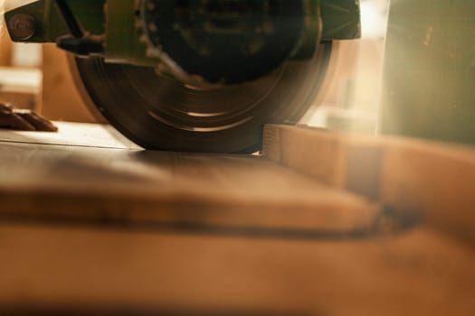 Wood saw while cutting lumber in a woodworking shop.