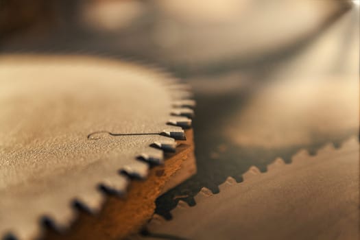 Small detail in focus of an adjustment, knob or in an element of woodworking tools, while the rest remains out of focus. Atmosphere and light in a craftsman carpenter's workshop. Wood and metal.