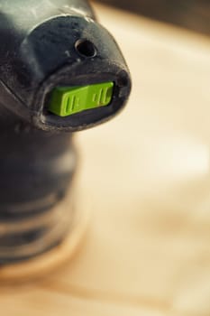 Small detail in focus of an adjustment, knob or in an element of woodworking tools, while the rest remains out of focus. Atmosphere and light in a craftsman carpenter's workshop. Wood and metal.