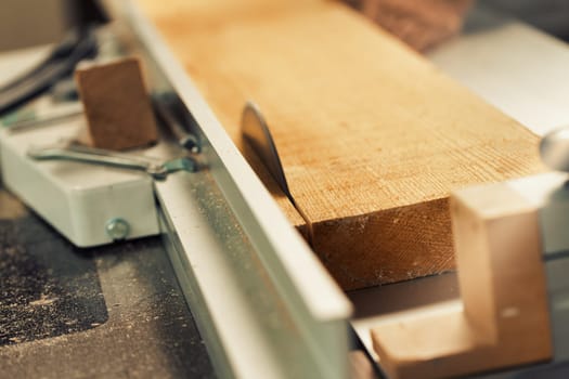 Wood saw while cutting lumber in a woodworking shop.
