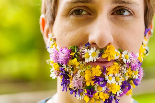 In a wooded setting, blossoms emerge not from branches but a man's face. This bond, real or self-perceived, signifies his reverence for the environment and its intricate beauty