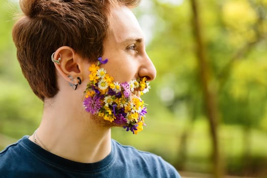Amid nature, a redhead stands out, face framed with flowers. His profound connection, whether actual or envisioned, speaks of his undying love for Mother Earth and its gifts