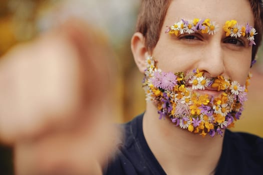 Spring blooms take the place of a man's beard and eyebrows. He exudes contentment, signaling approval with a thumb up, as he embodies nature's energy