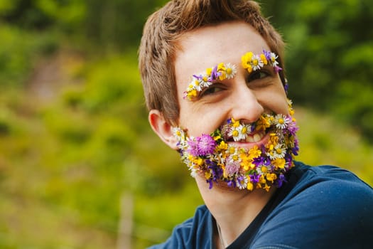 Standing in woodland, a man's face is alive with vibrant petals. This union with nature, tangible or perceived, showcases a lifestyle rooted deeply in environmental reverence