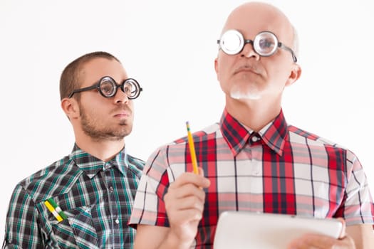 Older man with tablet and younger with pencils, quirky