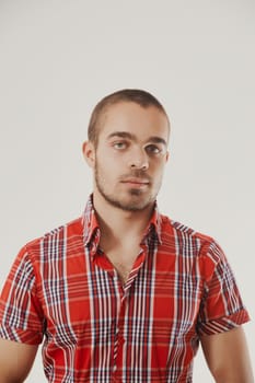 Serene expression characterizes man in colorful checkered attire