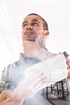 Double exposure of a man and a construction site portrays a blend of humanity and industry