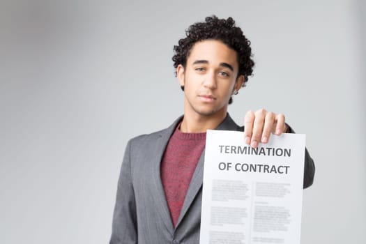 The decisive nature of the 'TERMINATION OF CONTRACT' is accentuated by his earnest expression