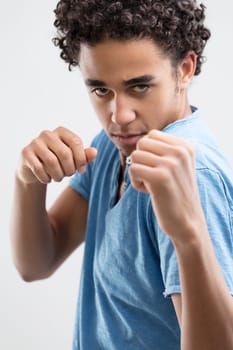 Poised in combat, the man's determined gaze and clenched hands reveal his intent