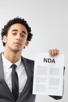 Captured in professional attire, the man's assertive pose underscores the significance of the 'NDA' he presents