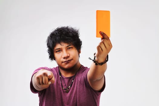 Emulating a soccer referee, the young man's gesture with his phone challenges the observer to embrace and understand mass communication's evolution