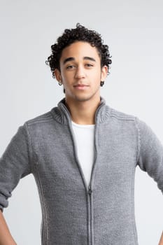 Green eyes, full of warmth, meet the viewer's gaze, with thick curly hair adding to his approachable appearance