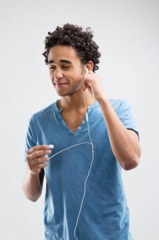Young man with a pleasant smile about to enjoy his music