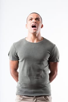 Man stands erect in a military stance, yelling an affirmative response. High chin, broad shoulders, shaved head, and a green military shirt sets him apart from the background