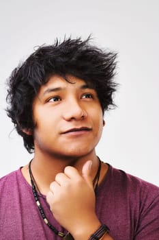 Black-haired young man from Central America muses over an idea that might secure his place in the world through his talents