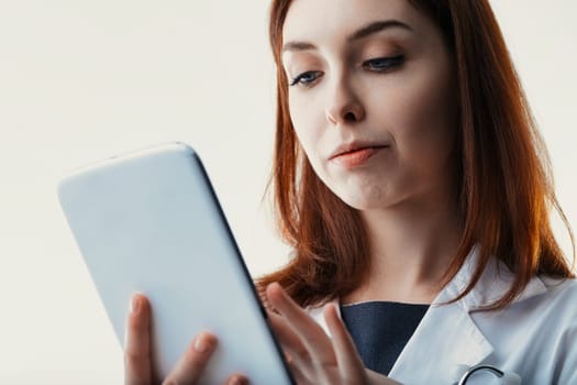 healthcare professional attentively scrutinizes a tablet, her focus indicative of the meticulous nature of medical review