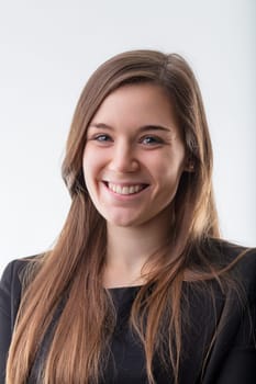 Young professional woman with a cheerful demeanor and warm smile, dressed in business attire