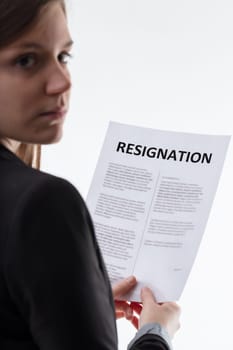 Solemn review of a resignation letter by a contemplative employee