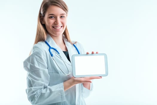 Confident healthcare provider presents a tablet with an empty screen, ready for patient interaction or medical data display