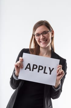 Encouraging professional with 'APPLY' sign exudes positivity. Join the team.