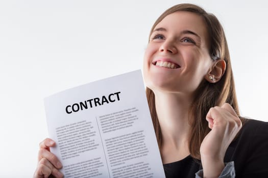 businesswomans enthusiastic expression holding a contract evokes a sense of accomplishment and the beginning of a new chapter