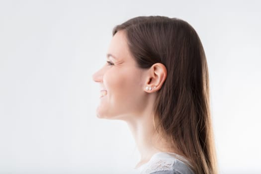 Woman's profile exudes cheer, her laughter echoing warmth and lightheartedness