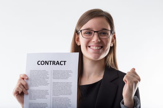 young businesswoman exudes confidence and joy as she proudly presents a freshly signed contract, a testament to her negotiation skills