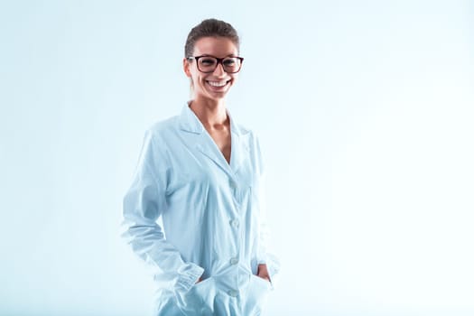 Woman in glasses, hair tied up, smiling with hands in her lab coat pockets. Specializing in science and technology, with internet and computers, has advanced her career. Intelligence, determination, a