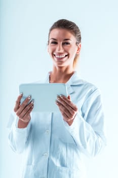 Smiling lady in white coat with a tablet, embodying a tech or research expert. She uses tech to validate data, sidesteps predatory journals, and promotes knowledge sharing via apps and internet
