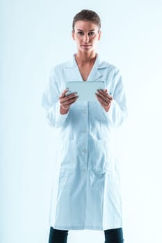 A determined woman in white coat holds a white tablet. As a STEM professional, she is skilled in data analysis, not swayed by predatory journals, always verifying and delving deeper