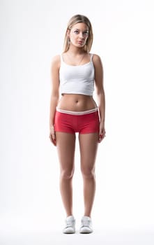 Fitness-ready stance, with a neutral background accentuating her poised figure
