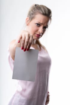Skeptical woman presents a blank card, her expression questioning its content