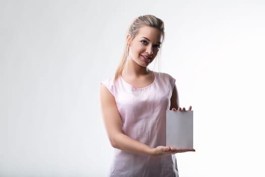 Confident young woman holds a blank card, ready for your message
