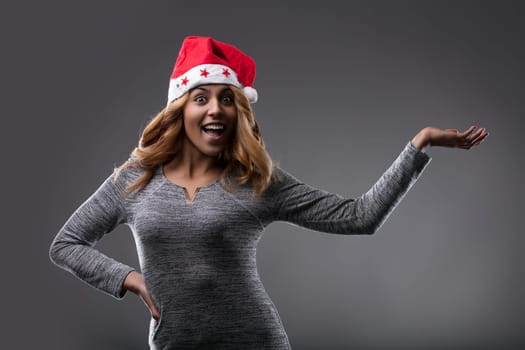 With a Santa hat and a gleeful smile, she embodies the cheer of the season as shows YOUR PRODUCT