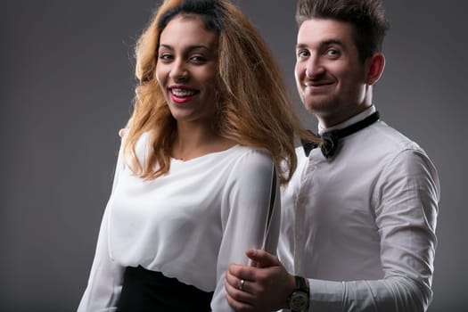 Close-up on joyous faces, her charisma matched by his cheeky expression