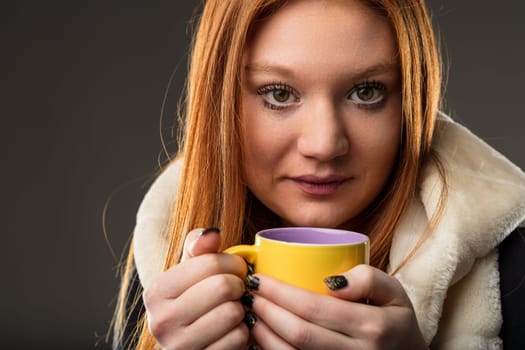 ontemplative redhead with a cup of tea, symbolizing warmth and relaxation
