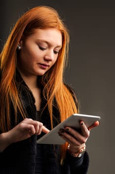 Modern communicator, her tablet a tool for engaging with a global audience from anywhere