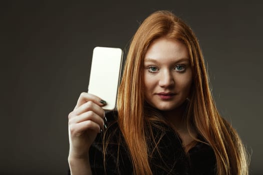 potential of technology held in one hand, as a woman displays a smartphone screen