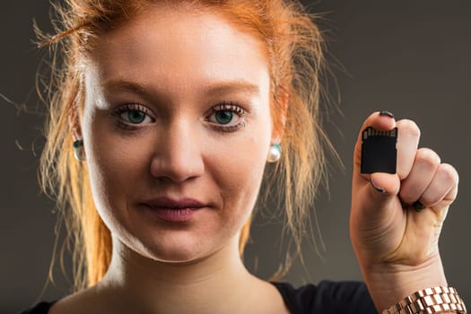Expert in digital storage presents a micro SD card, symbolizing the vast potential of compact technology