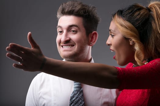 Elegant pair in a tense moment her open-mouthed admonishment dominates