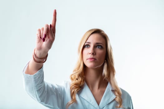 Woman in white, blurred, typing in air where you'll place your floating graphic, a scientist at a high-tech firm