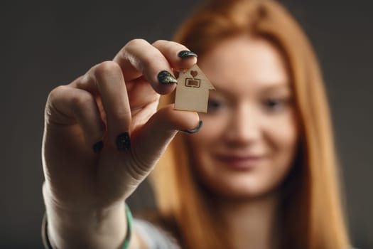 The concept of homeownership captured in the hands of a thoughtful woman