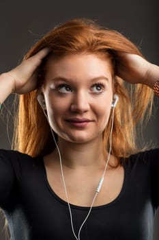 Red-haired music enthusiast experiences a deep connection to her playlist, her earphones delivering every note