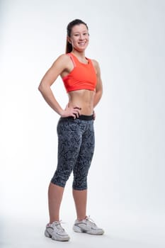 A sporty woman, hands on her hips, smiling, echoes the sentiment that a great brain requires a fit body to transport itUnless you are telepathic.