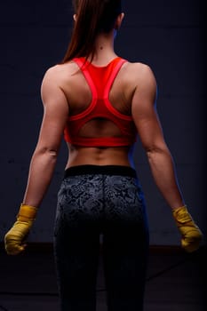 Kick-boxer, toned, muscular back leading to firm behind, undeterred by opinions. Aware of her attractiveness, ready to confront