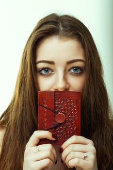 The rich, embossed leather journal held close to her face only heightens the mysterious allure of her gaze